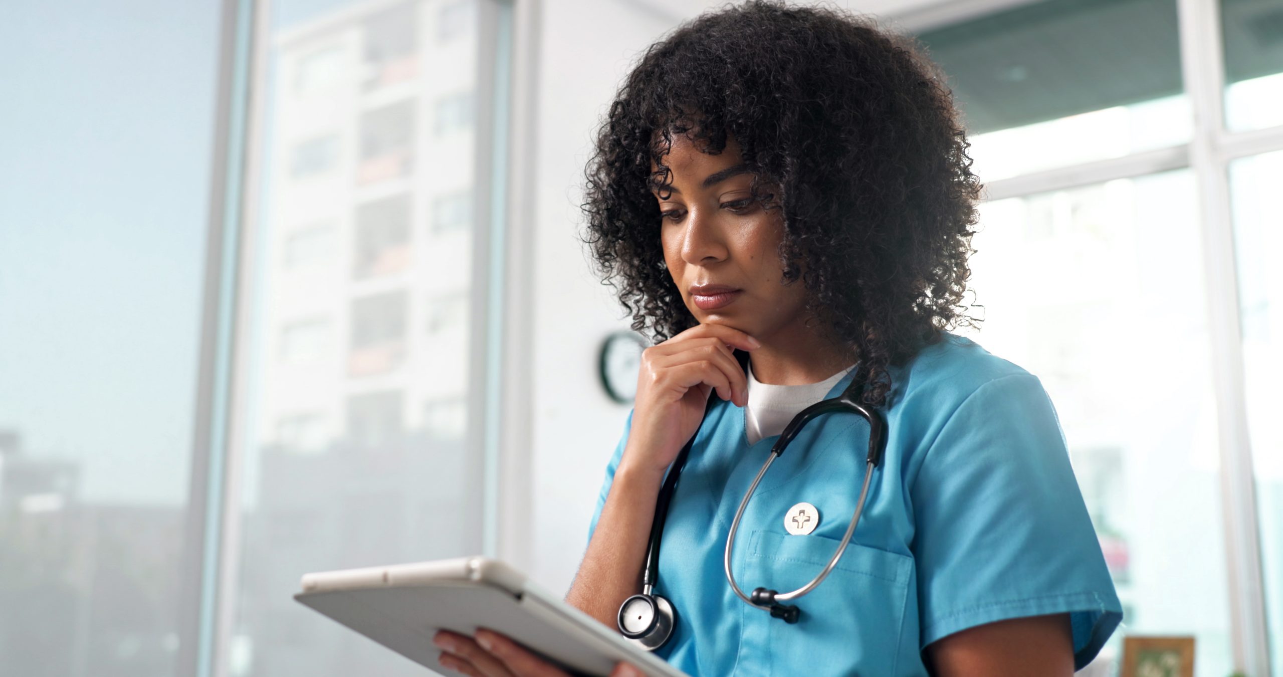focused female nurse using digital tablet in a bri utc