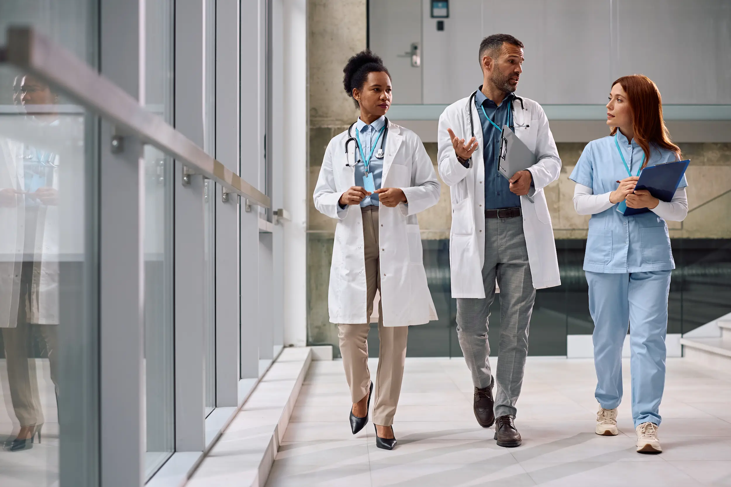 team of healthcare experts talking while walking t 2026 03 25 04 07 22 utc